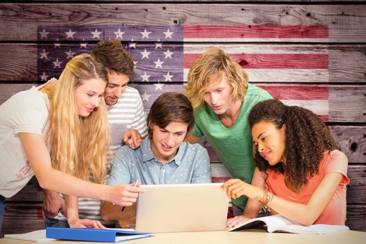 College students using laptop in library against composite image of usa national flag