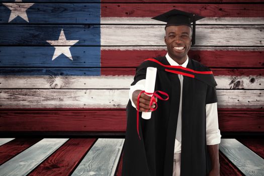 Man smilling at graduation against composite image of usa national flag