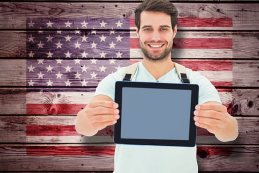 Student showing tablet against composite image of usa national flag