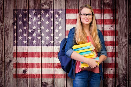 Pretty student in the library against composite image of usa national flag