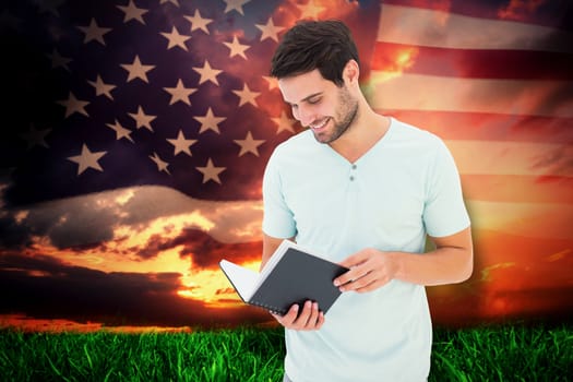 Student reading book against composite image of united states of america flag