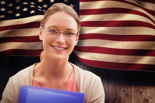 Teaching student smiling against composite image of digitally generated united states national flag