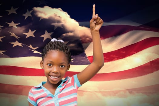 Smiling pupil with hand up against composite image of digitally generated american flag rippling