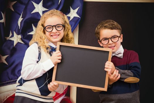 Pupils showing chalkboard against american flag on chalkboard