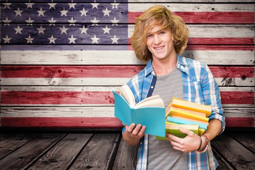 Student reading book against composite image of usa national flag