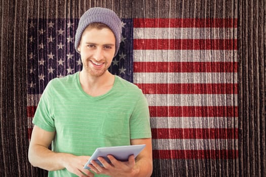 Student using tablet against composite image of usa national flag