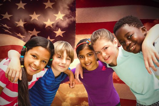 Happy children forming huddle at park against composite image of digitally generated united states national flag