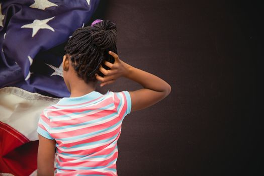Pupil thinking against american flag on chalkboard
