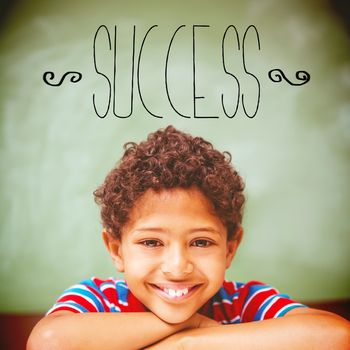 The word success against little boy smiling in classroom