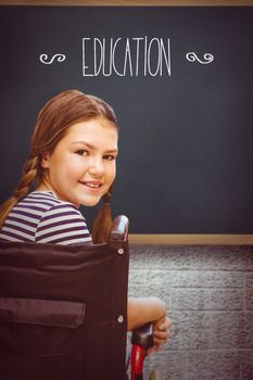 The word education and girl sitting in wheelchair in school against teal, blue