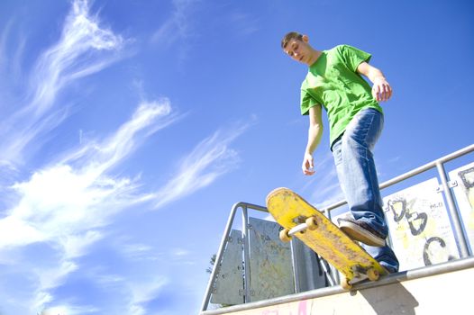 Sport conceptual image. Teenage skateboarder standing on the ramp with skateboard.