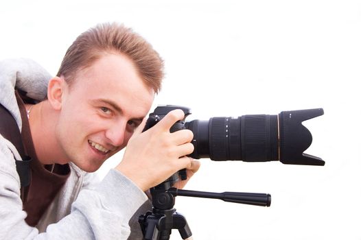 Professional photographer taking pictures and smiling. Isolated picture.