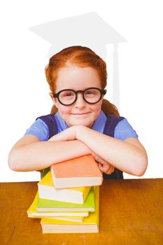 Cute pupil at desk against silhouette of graduate