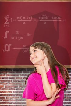 Cute little girl thinking and looking up against red background
