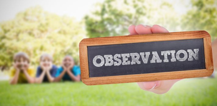 The word observation and hand showing chalkboard against happy friends in the park 