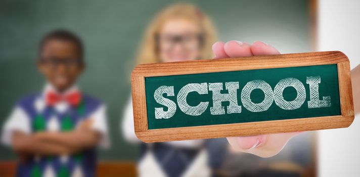 The word school and hand showing chalkboard against pupils smiling at camera with arms crossed 