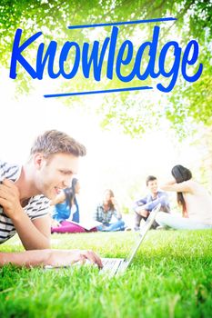 The word knowledge against happy student using his laptop outside