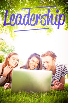 The word leadership against happy students using laptop outside