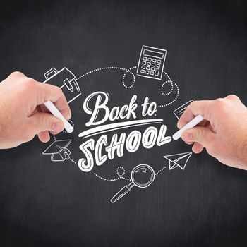 Business man writing with chalk against blackboard