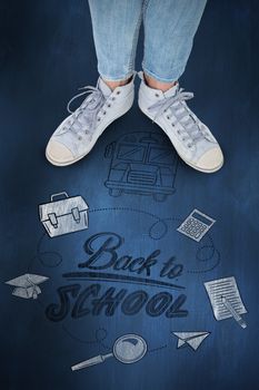 Woman wearing trainers  against blue chalkboard