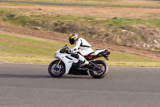 Race bike exiting out of a corner.