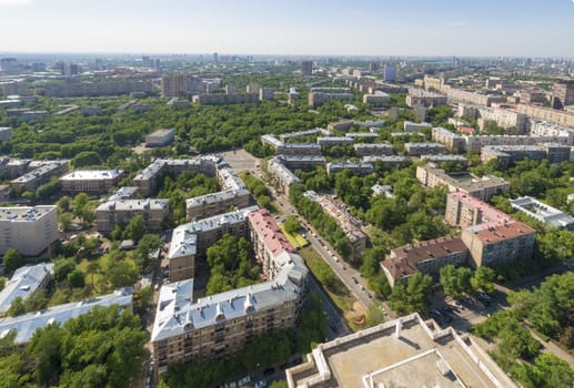 View of Moscow modern residential quarters at sunset on top of the roof of a tall building