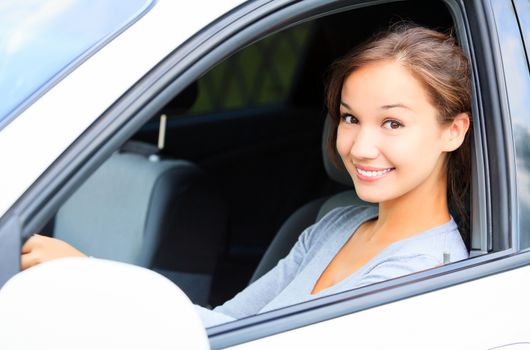 Girl in a car smiling to you