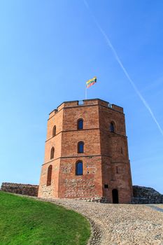 View of historical old  Gediminas Tower with lithuanian flag, on blue clear sky background.