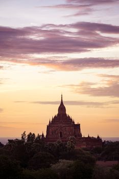 Sunset scenic view of ancient temple in Bagan with dramatic clouds, Myanmar