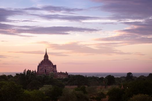 Scenic colorful sunset of ancient temple in Bagan with dramatic clouds, Myanmar