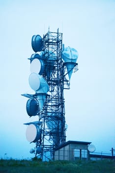 radio antenna tower with blue sky of evening twilight