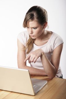 Young woman sitting at a table in front of her computer