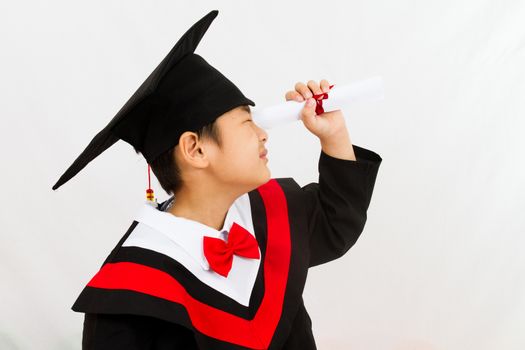 Chinese little boy graduation in white backround studio shot.