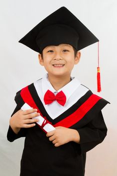Chinese little boy graduation in white backround studio shot.