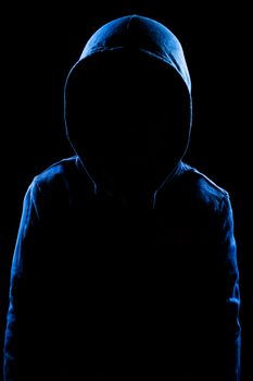 Anonymous user with hood in black background studio shot, faceless.
