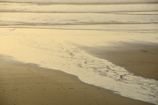 sand pattern from a creek flowing on a beach