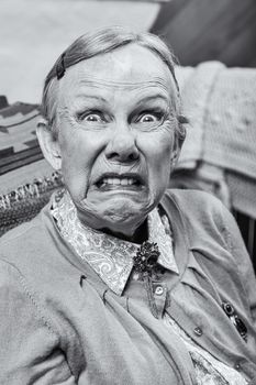 Elderly woman making a scary face at the camera