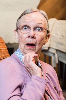 Surprised old matron woman looking at camera