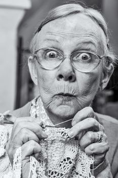 Woman with crochet and funny facial expression