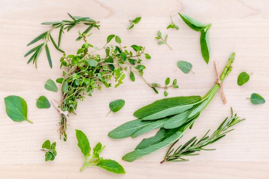 Fresh green herbs harvest from garden on wooden rustic background .