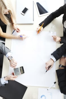 Business people sitting at table with electronic devices on meeting