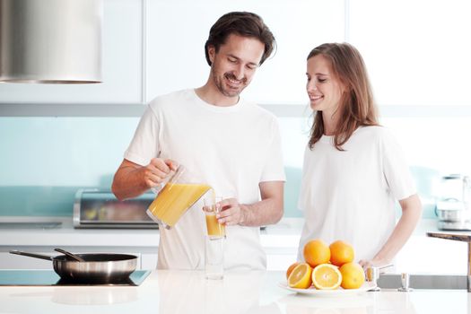 couple cooking breakfast at kitchen