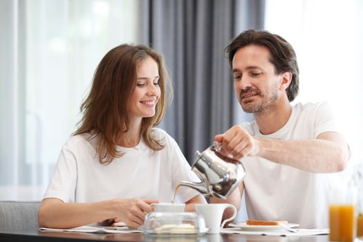 couple eating breakfast at kitchen