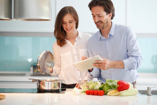 couple cooking dinner at kitchen