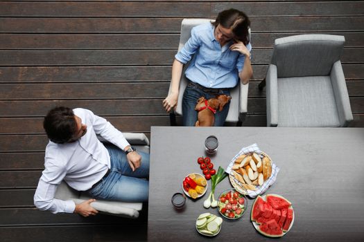 couple eating behind the table from top view