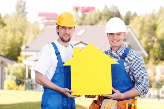 two workmen holding yellow house symbol