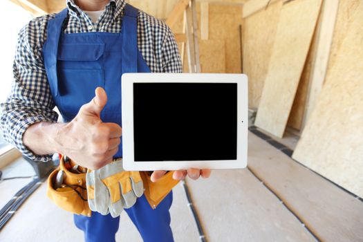 close-up of workman with tablet and thumbs up