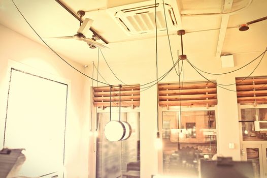 Interior conceptual image. Cafe interior. Windows and ceiling with ventilator and air conditioning.