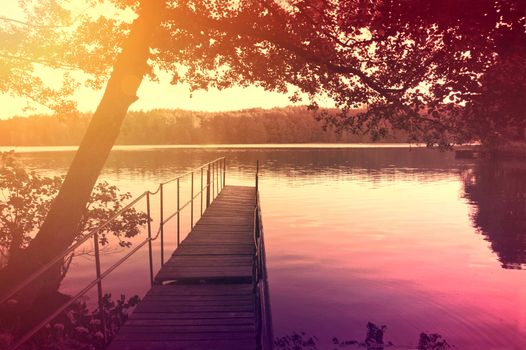 Nature conceptual image. Evening on the lake at summer. Instagram vintage picture.