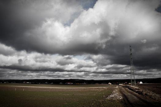 Nature. Dark sullen clouds over field.